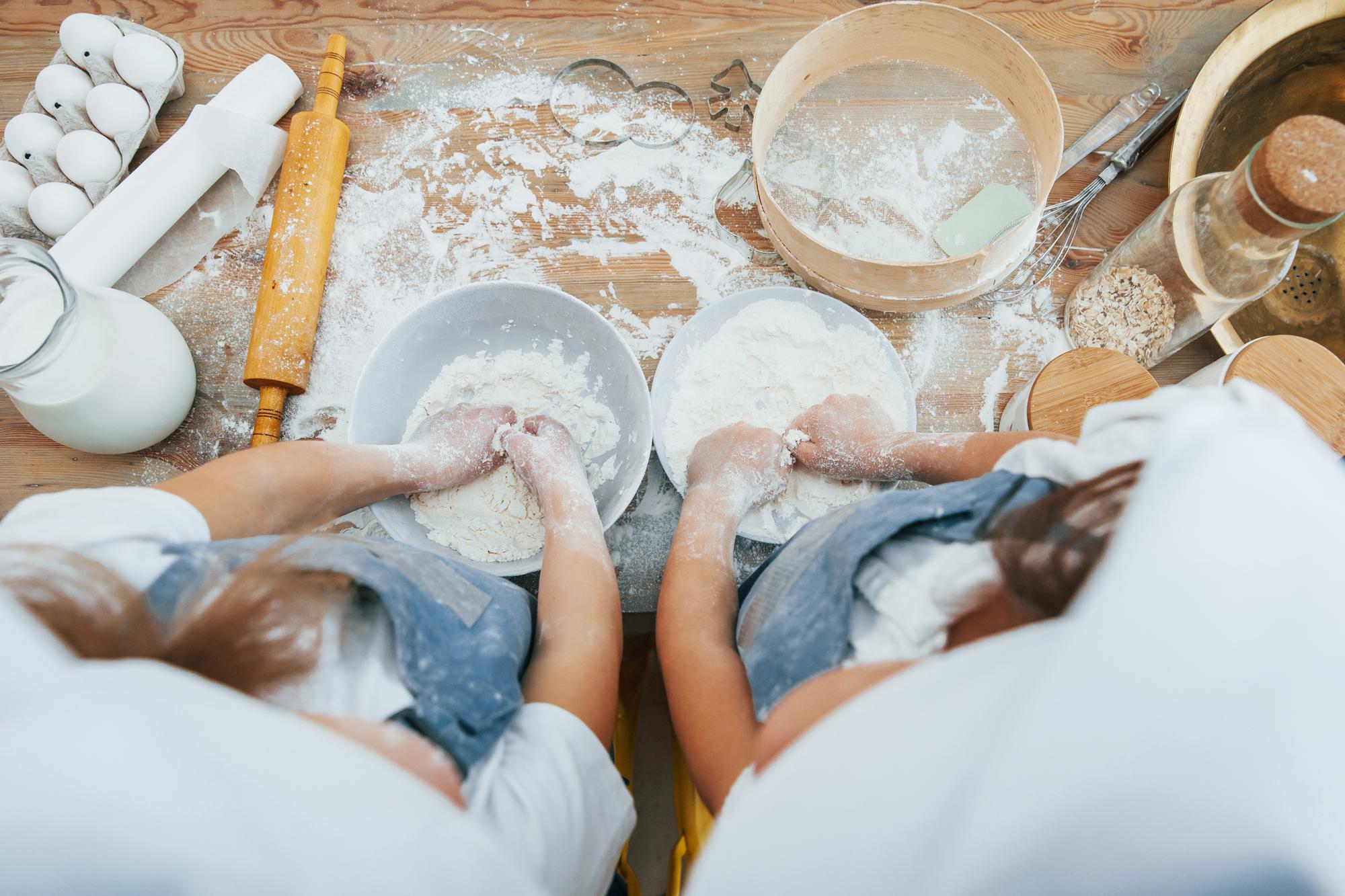 Hands shaping dough in workshop